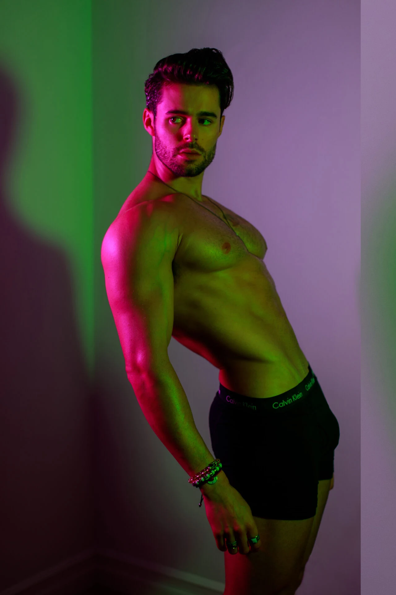 Editorial men's portrait, colored gel lighting, side profile